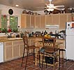 kitchen with chairs and overhead fan in beautiful retreat house for sale by owner